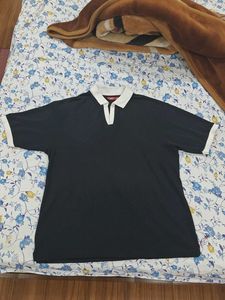 This is a black polo tshirt.With white collar.