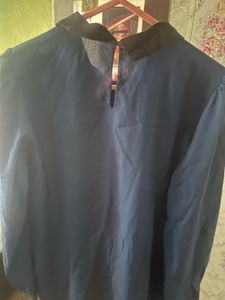 Elegant navy blouse with floral-embellished collar
