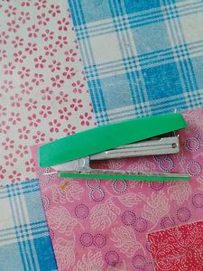 Stapler with pin remover