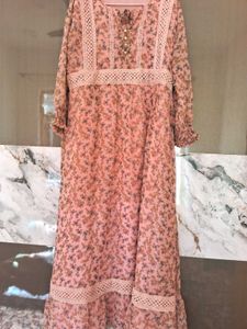 A pink floral gown with white lace trim