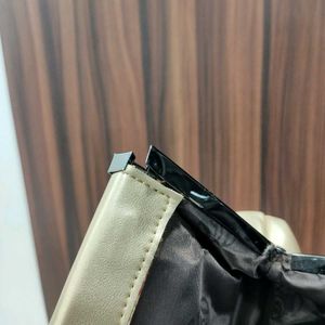 NWT Embelle Gold Cluth With Black Metal Sling