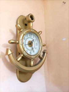 present analog wall clock with glass pendulum