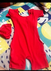 Swimming costume with cap