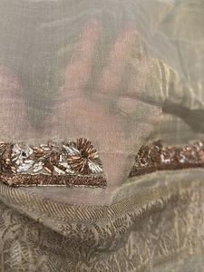 designer blouse piece in soft gold with hand work