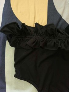 Black Ruffle Tube Bodysuit From NEWME