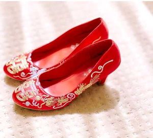 A pair of red, embroidered flat shoes..