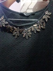 Textured Black Top with Leaf Embellishments
