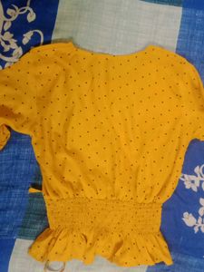 A Mustard Yellow Cinched Waist Top .