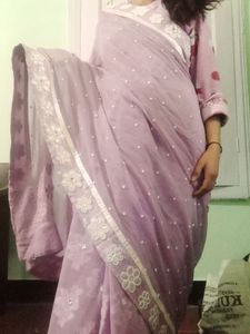 A very beautiful lavender colour saare with jdau work and shimmery padded blouse