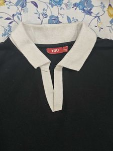 This is a black polo tshirt.With white collar.