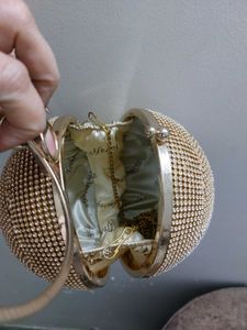 Round Studded Handheld Clutch With Metal Sling