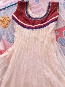 Off white net anarkali with beautiful neckline and beads embroidery. Full length anarkali