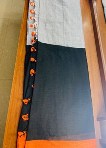 Black orange cotton blend saree with pompoms