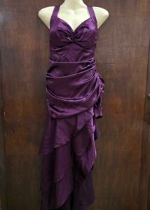 Purple ruffle dress with tailing on left side.