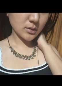 Brown Wallet And A Necklace
