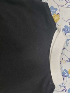 This is a black polo tshirt.With white collar.