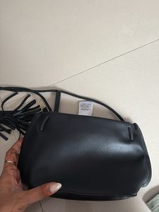 Chic Black Sling Bag with Tassel Detail