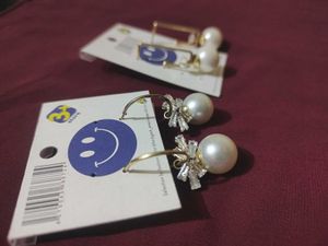 2 pair of gold plated pearl earrings with a stone