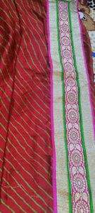 Bright red Gujarati leheriyu saree with pink and green border lace with blouse