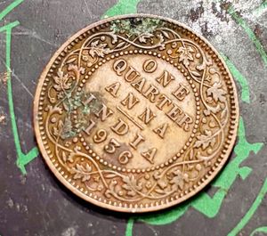“1936” British India one-quarter Anna coin.