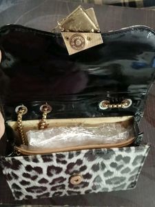 This Is A Sling Bag It Has Cheetah Print