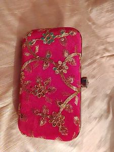 red clutch with zari work