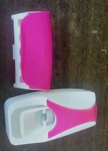 Toothpaste dispenser with toothbrush holder