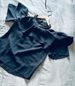 women’s black blouse featuring short sleeves, a so