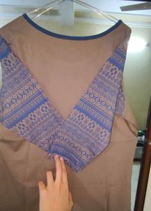 Brown T-shirt with Patterned Blue SleevesCita