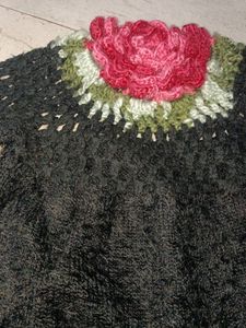 A soft sweater with flower on it.