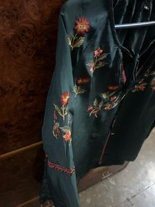 Bottle, green colour, full sleeves, top with elastic at the sleep, end and embroidery work in the front and in the arms of the top