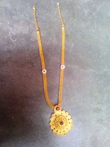 Intricate Gold Tone Filigree Necklace with Red Sto