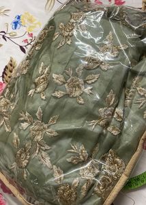 A Heavily Embroidered Pista Green Ethnic Gown
