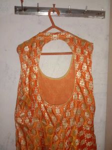 Orange sleeveless and backless gown