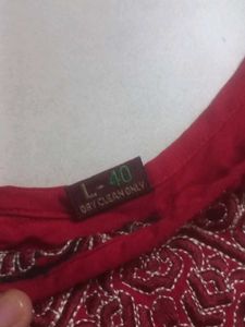 A red long size straight kurti