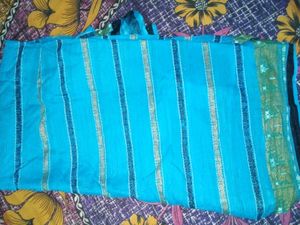 Womens Blue Cotton Saree With Golden Bady.