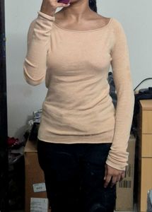 light beige or nude-colored long-sleeve top