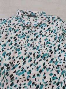 a middi of white colour having green nd black dots