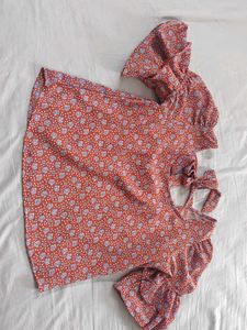 Red top with floral blue pattern