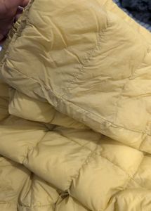 Uniqlo ultra light down jacket in butter yellow