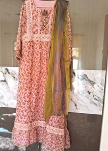 A pink floral gown with white lace trim