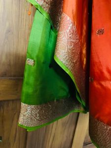orange colour silk saree with green mundani