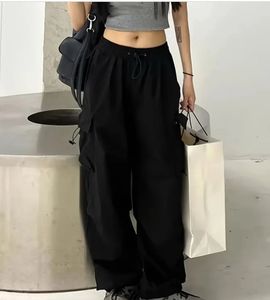 Black trendy parachute pants with adjustable lows