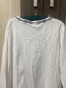 Blue Embroidery On A White Tunic