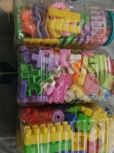 Kids Playing Combo Of 4 Blocks And Alphabet