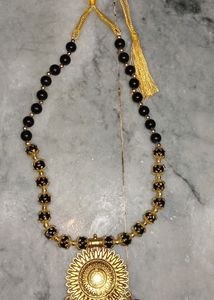 Black and golden preals necklace