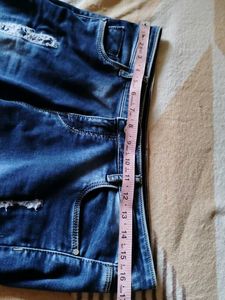 Navy Blue Ripped Jeans With A Design On Bottom