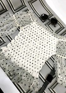 white, sheer top with black polka dots