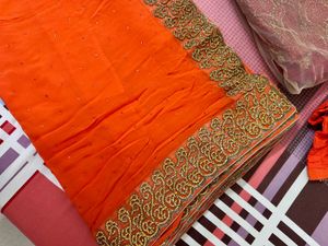 Vibrant Orange Saree with Stone Work and Ornate Em
