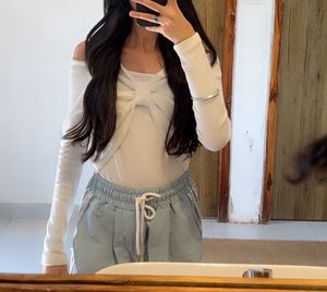 Trendy bowy white full sleeves top with a cut on s